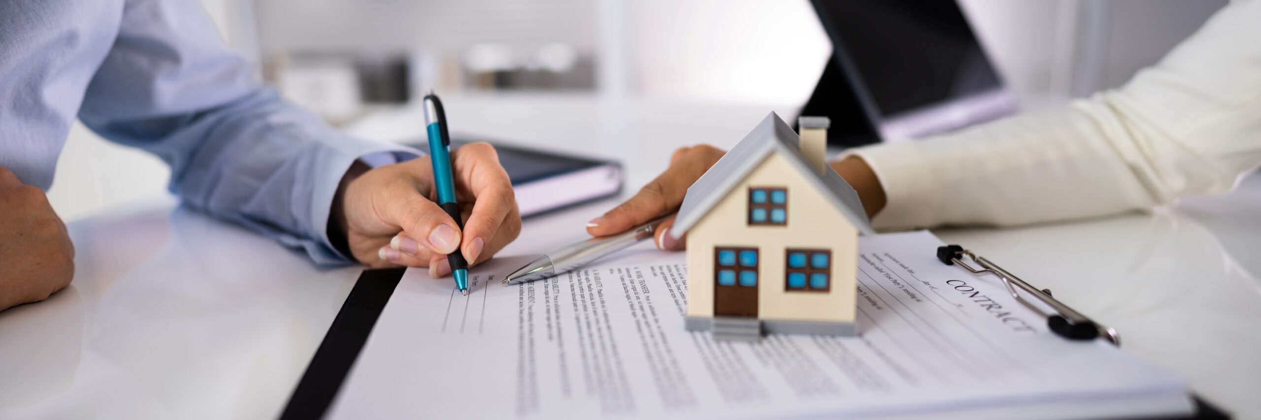 image of people signing paperwork
